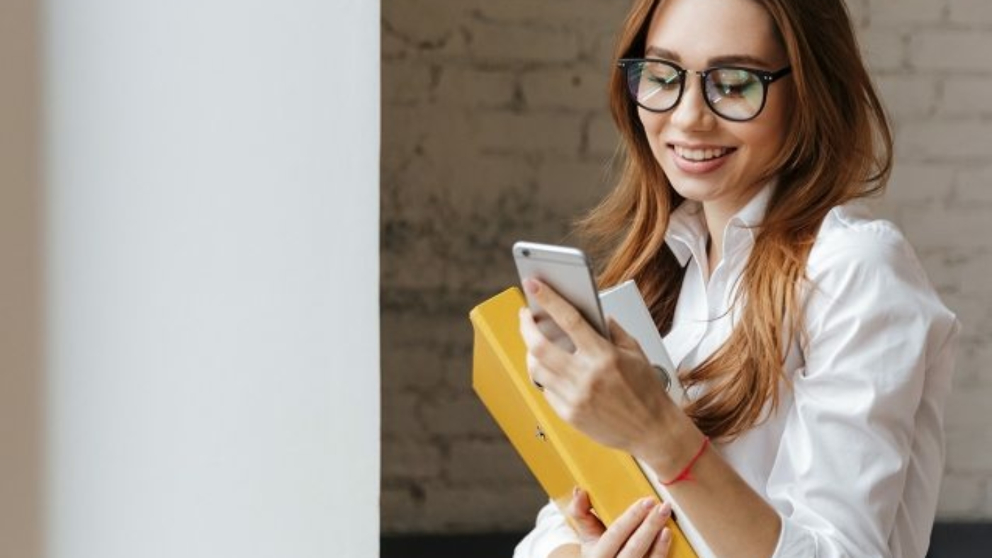 happy-business-woman-indoors-using-mobile-phone-P9WS3SD-637x478