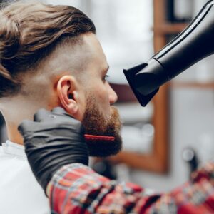 Man with a beard. Hairdresser with a client.