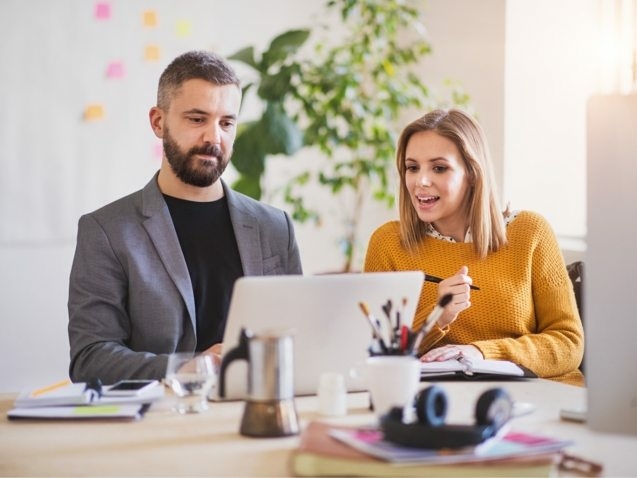 two-business-people-with-wheelchair-in-the-office-P7XLSBC-637x478