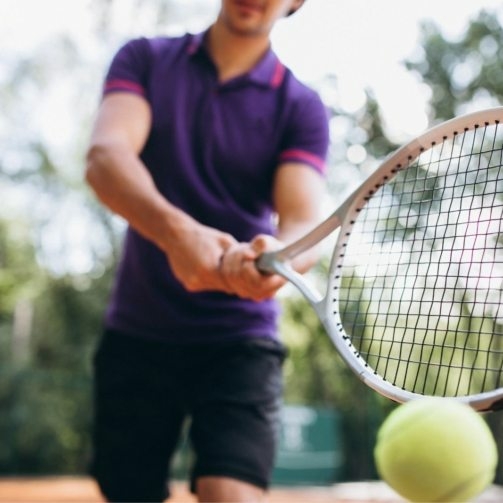young-man-tennis-player-court-tennis-racket-close-up3-503x503