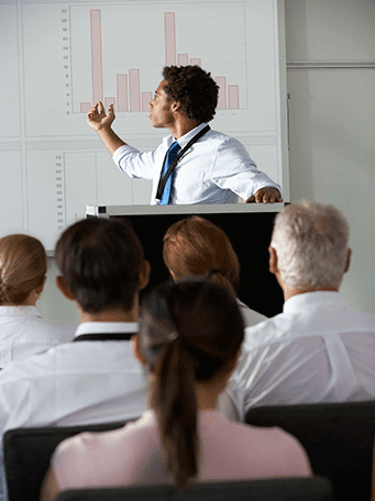 op_young-businessman-delivering-presentation-at-PF276WZ