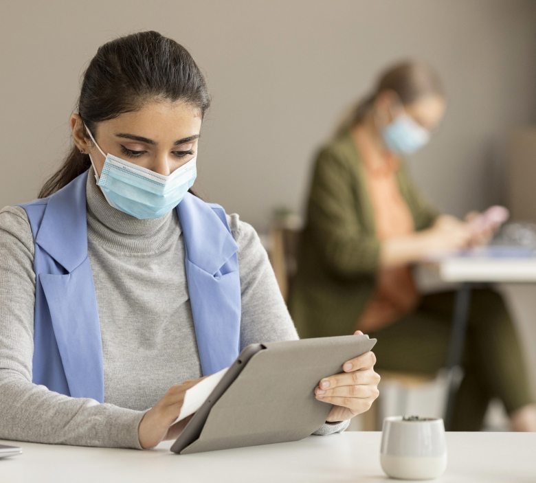 employee-disinfecting-electronic-device-780x703